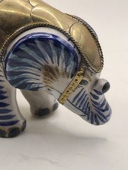 Mexican signed elephant with brass armour in white and blue ceramic. Vintage