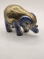 Mexican signed elephant with brass armour in white and blue ceramic. Vintage